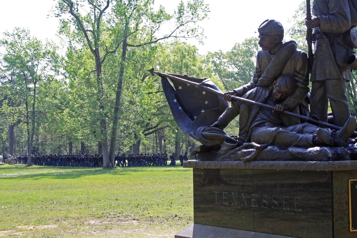 A bronze statue of three civil war soldiers stands on a base with the word "Tennessee" written on it.