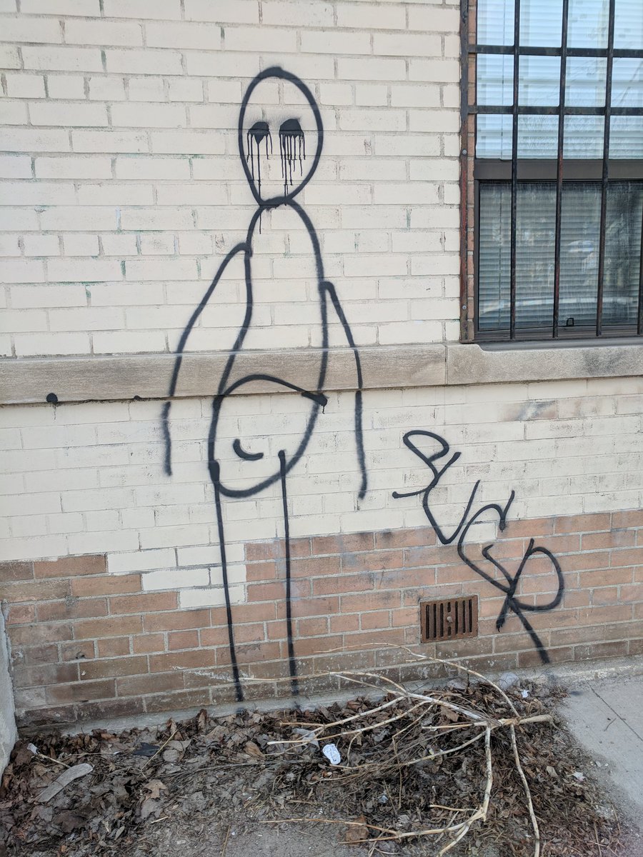 Graffiti of stick man with crying eyes and smiling genital area