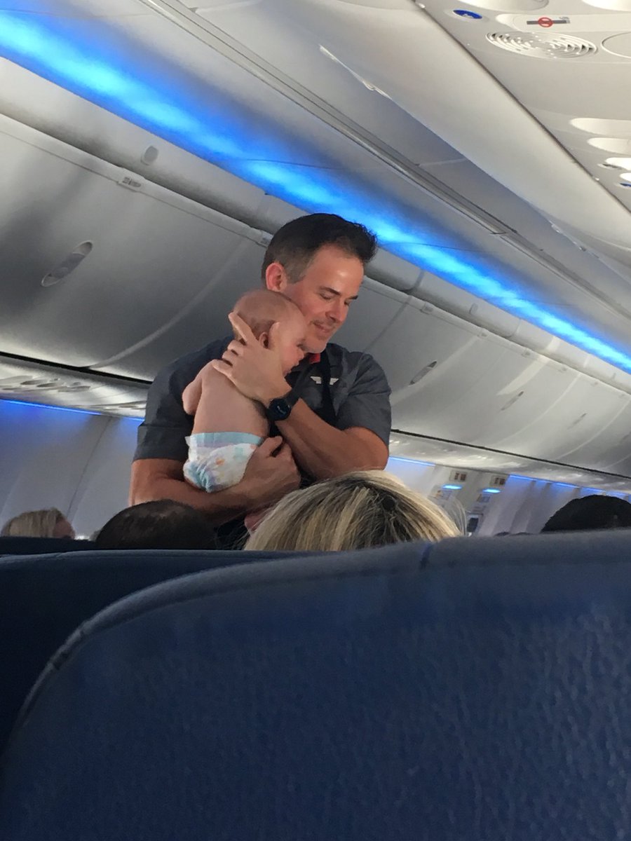 karloxide's tweet photo. This @SouthwestAir flight attendant held this crying baby for 30 min on our flight today to relieve his parents💕. I will never fly another airline! https://t.co/lDi6RUEbGN
