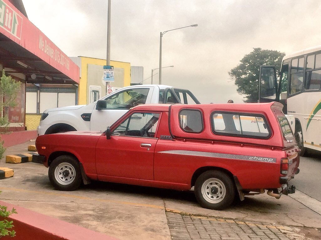 jbenedictbrown's tweet photo. South Africa has a rich car culture, with lots of local production. The “bakkie” [pick-up] is ubiquitous. Next to one of our #ProjectIthuta Ford Rangers is a lovingly maintained Nissan 1400 Champ, built in South Africa 1971-2008. This is probably 1993 or later. https://t.co/zMbvljuyCz