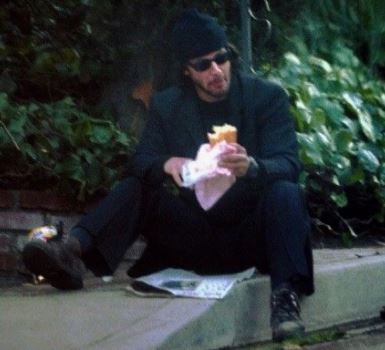 keanuthings's tweet photo. keanu reeves eating a sub &amp; reading a newspaper on the sidewalk https://t.co/EQdgE9zJM6