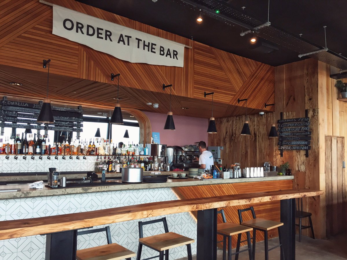 WanderingCoast's tweet photo. Finally got around to checking out Swim, the new cafe bar on the beach at Lyme Regis. We loved the Palm Springs vibe! Our own slice of SoCal, here in West Dorset. We appreciated the generous choice of vegan food too. https://t.co/yxJy72huYc