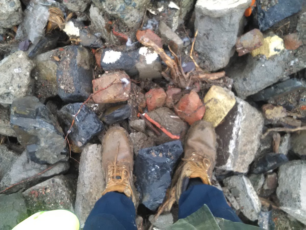GWCEL's tweet photo. Standing on a pile of rubble in my suit, my boots, and the lashing rain. https://t.co/ero12SHkQ6