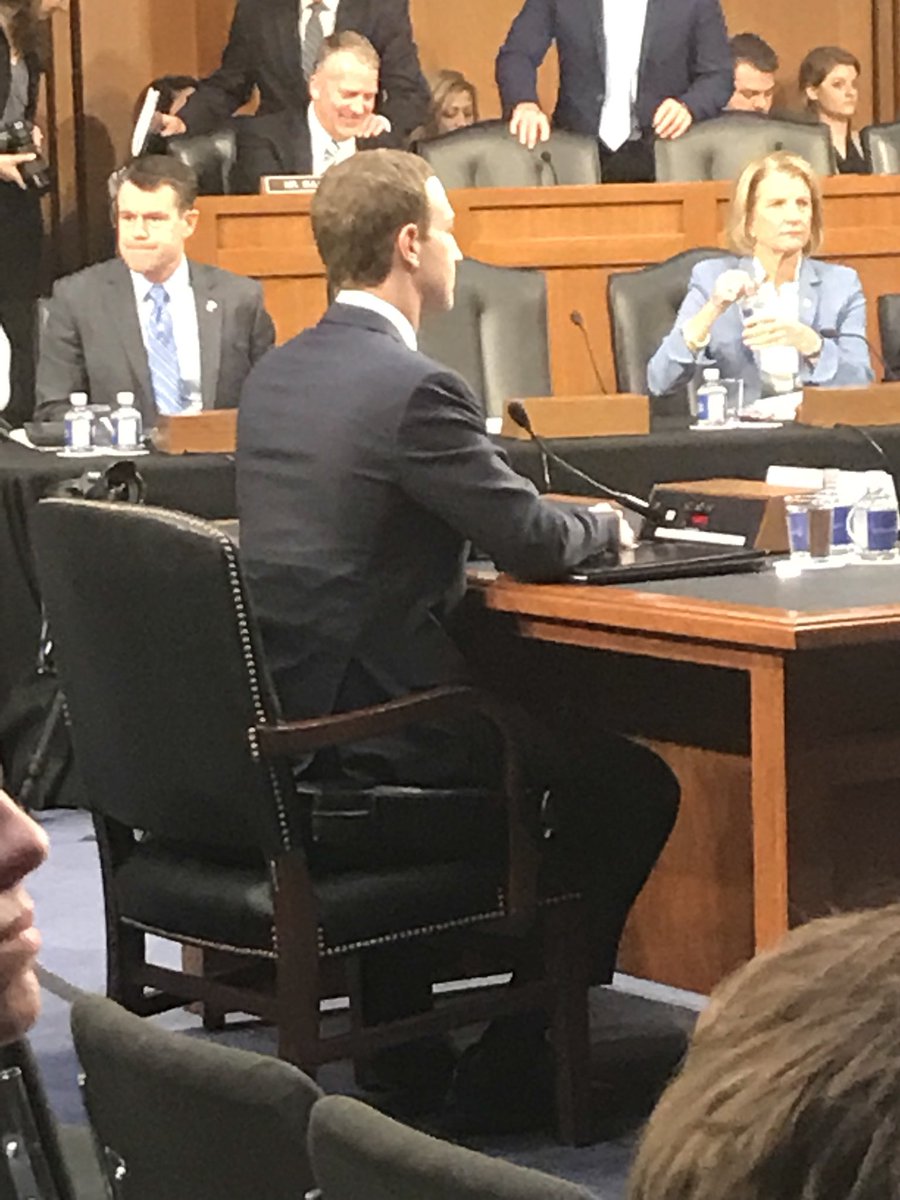 Milbank's tweet image. Zuckerberg takes his seat... on a 4-inch cushion.