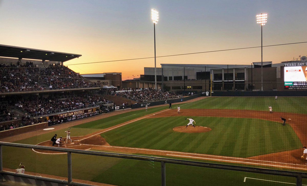 View of the baseball diamond from behind first base at sunset