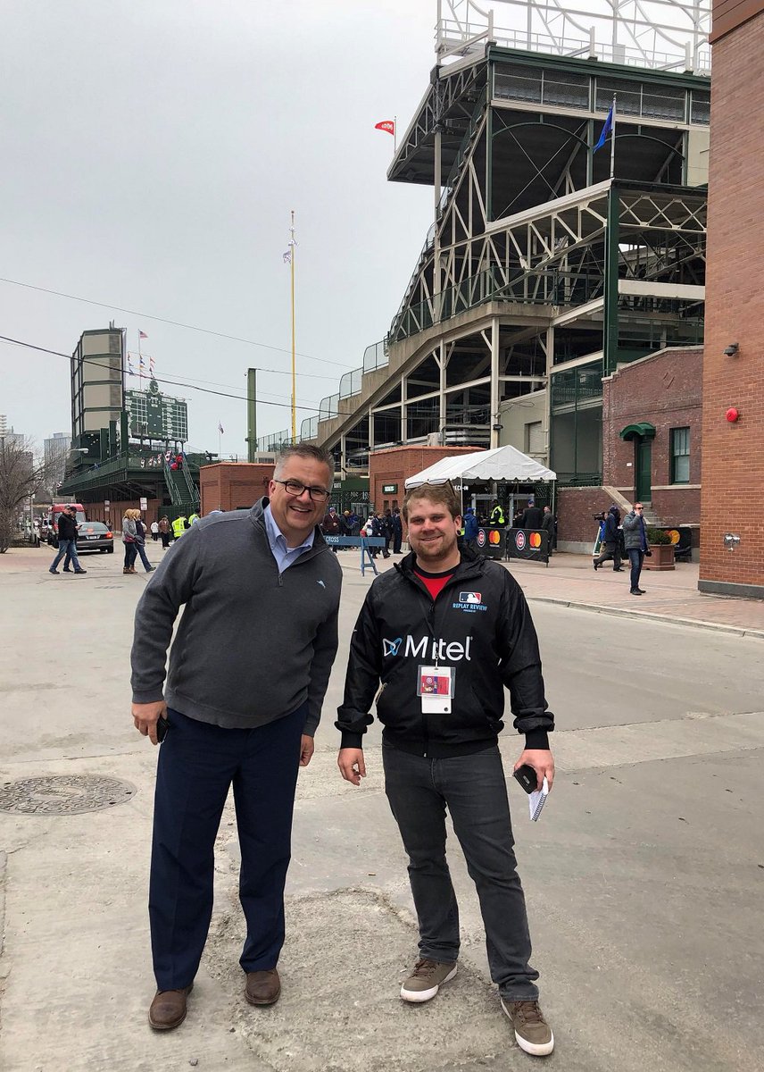 Mitel's tweet photo. "Hey Mitel Man!" Mitel CMO Wes Durow runs into @MLBReplays tech just outside of Wrigley Field prior to last night’s game. #MakeTheRightCall https://t.co/J6dVe5Mcuc