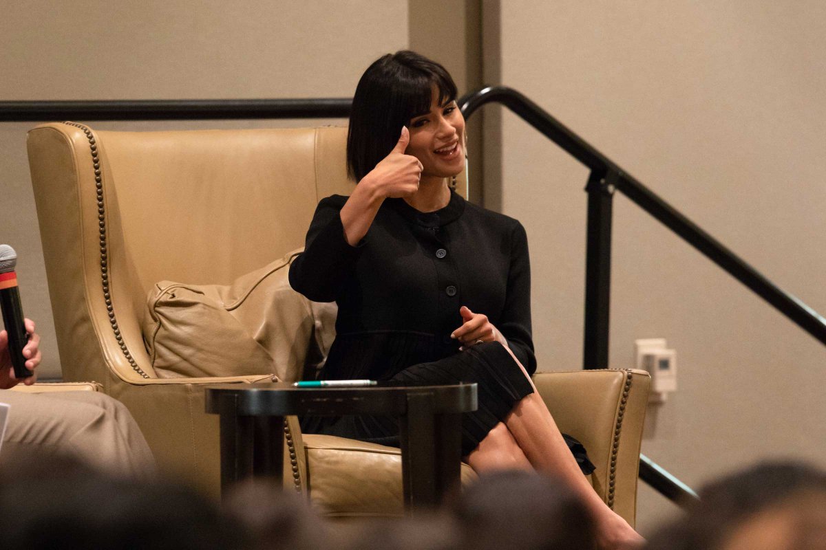diane guerrero giving a thumbs while seated on stage