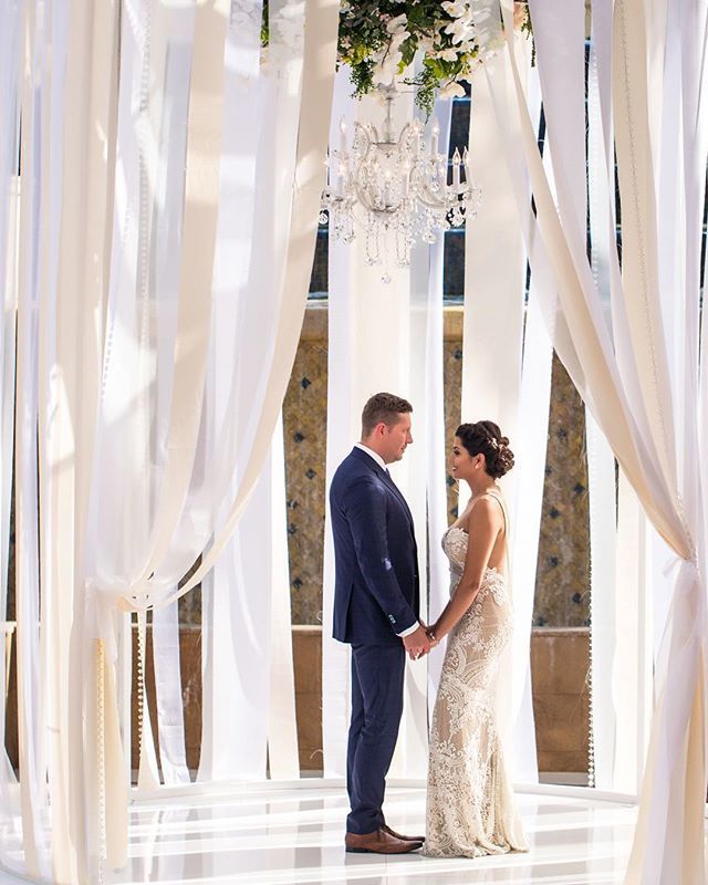 Ribbon walls reimagined!  We created this stunning, intimate ceremony space and topped it with a stunning chandelier and floral drop. 
Las Vegas Wedding Planner <a href="/andreaeppolito/">Andrea Eppolito</a> 
Photo @haleyshandrophoto 
Decor <a href="/dbdweddings/">DBD Weddings</a> 
Dress <a href="/berta/">Berta</a> 
Venue <a href="/fslasvegas/">Four Seasons Vegas</a> ift.tt/2JGHAk6