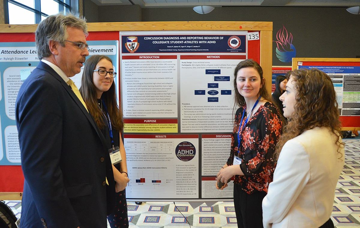 DuqBrainBusters's tweet photo. Congrats to Brain Busters Ashley Evans, Kaelin Agar and Greta Spitzer on their presentation on the reporting behaviors of collegiate athletes with ADHD and concussions at the @duqedu Undergraduate Research Symposium! https://t.co/5Kj617tmnQ