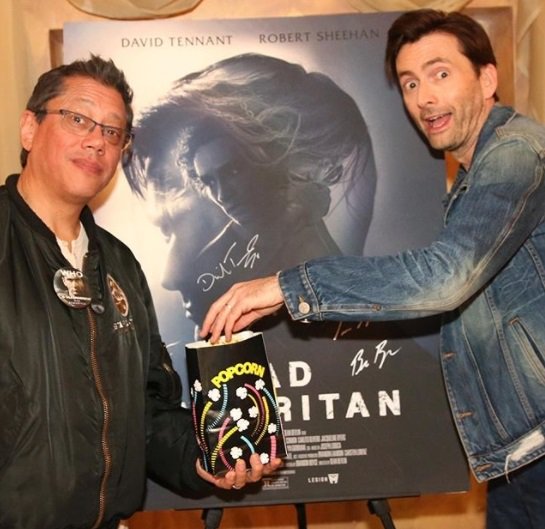 Dean Devlin and David Tennant in front of a Bad Samaritan poster at Silicon Valley Comic Con