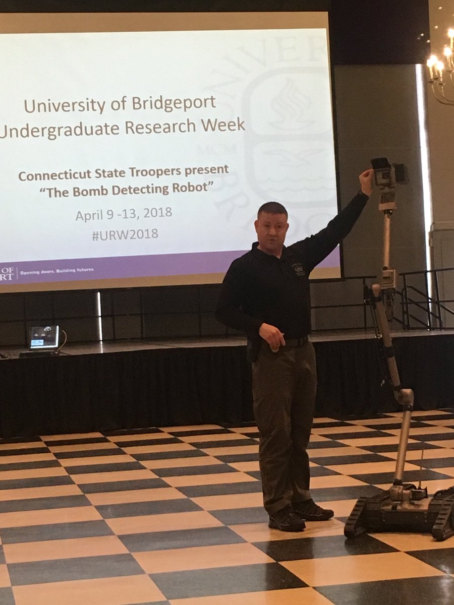 Research_UB's tweet image. Connecticut State Troopers demonstrate their bomb detecting robot during Undergraduate Research Week #URW2018