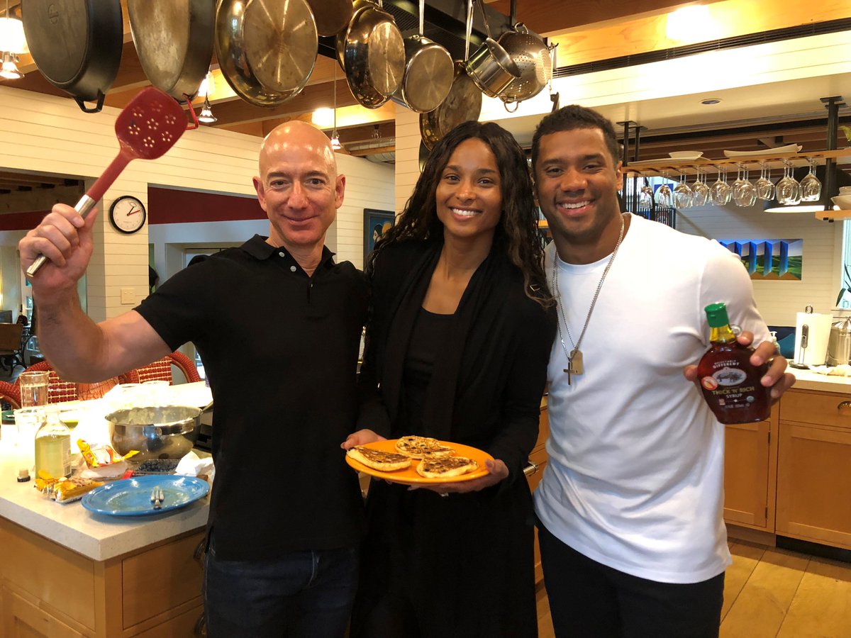 JeffBezos's tweet image. I made pancakes on this rainy Seattle morning for @ciara and @DangeRussWilson. These guys are as fun as they are talented. Inspiring too. And Russ and I ate our weight in pancakes! #funfriends