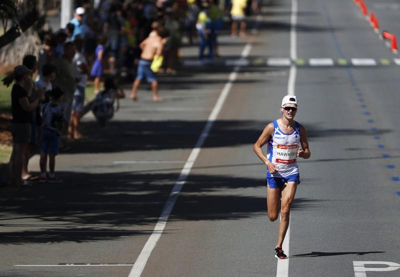 Reuters's tweet photo. Hawkins collapse overshadows men's marathon https://t.co/9QdII2g5Ee https://t.co/QhrTpcXRtQ