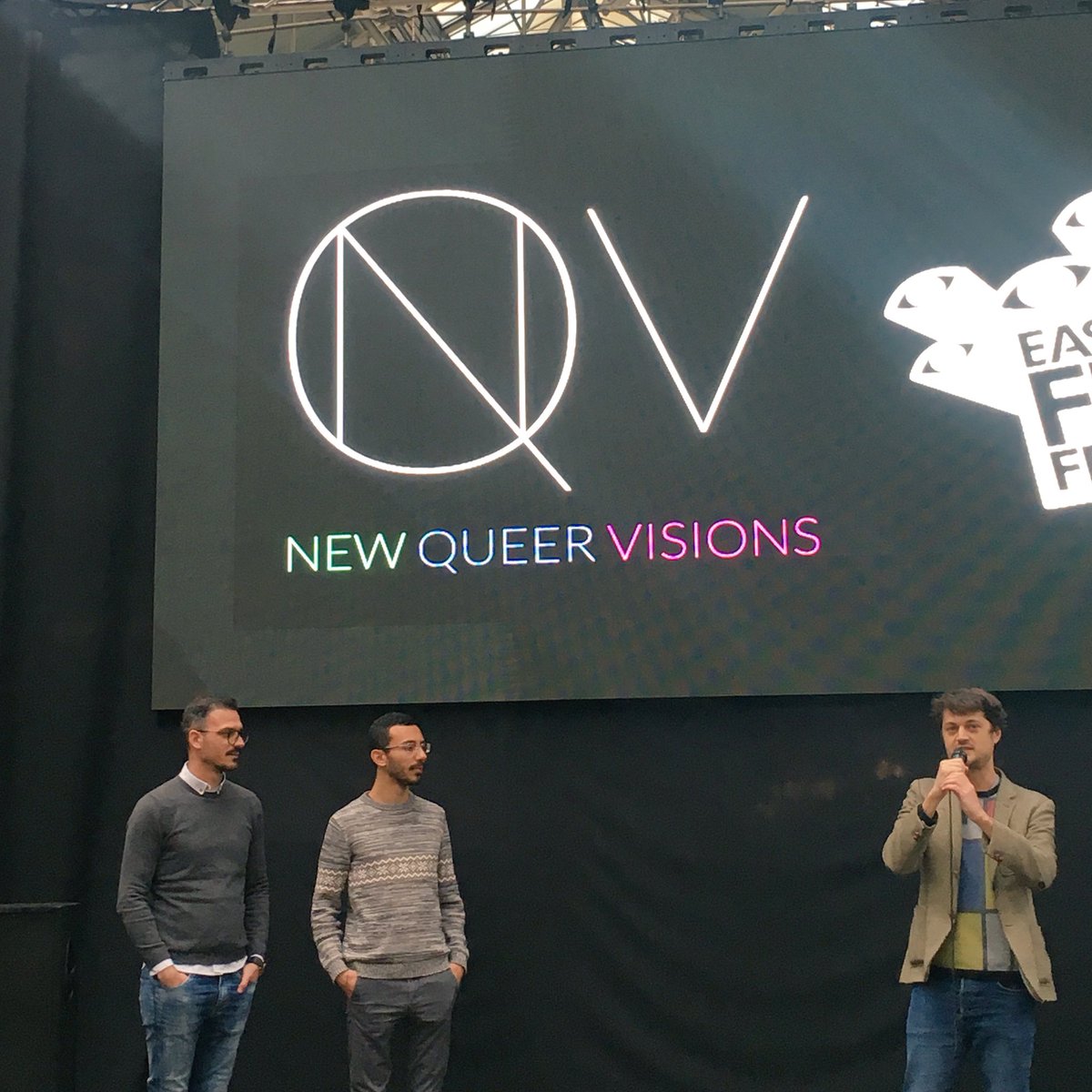 EastEndFilmFest's tweet photo. “There are lines between cultures, people, countries. Whether to escape or to find something new - these stories are crossing those lines.” @simonsavory introduces NEW QUEER VISIONS: THE 36TH PARALLEL, with a little help from filmmakers Juan David and Mario Psarras. #EEFF2018 https://t.co/a663G4AKvc