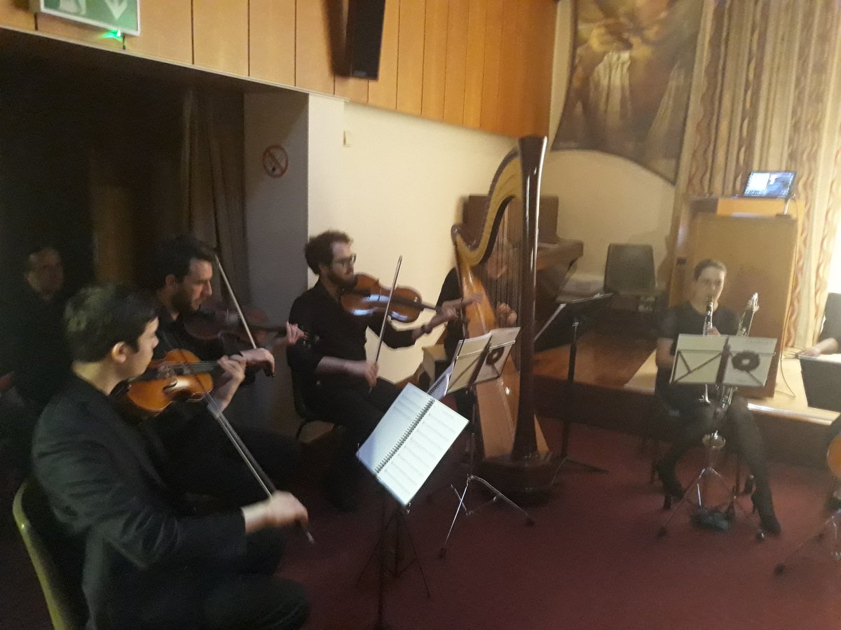 PolishEmbassyUK's tweet photo. The participants of the event enjoy a truly unique dialogue between '#Kochanowski and #Shakespeare" presented by Anita Jones Dębska, Iain Smith and Maciej Grabowski,  beautiful Polish music by '#AlternativeStrings' and folk dancing by 'Wiesniacy' @ShakespeareBT @PLInst_London https://t.co/KyQ8U4EzG7