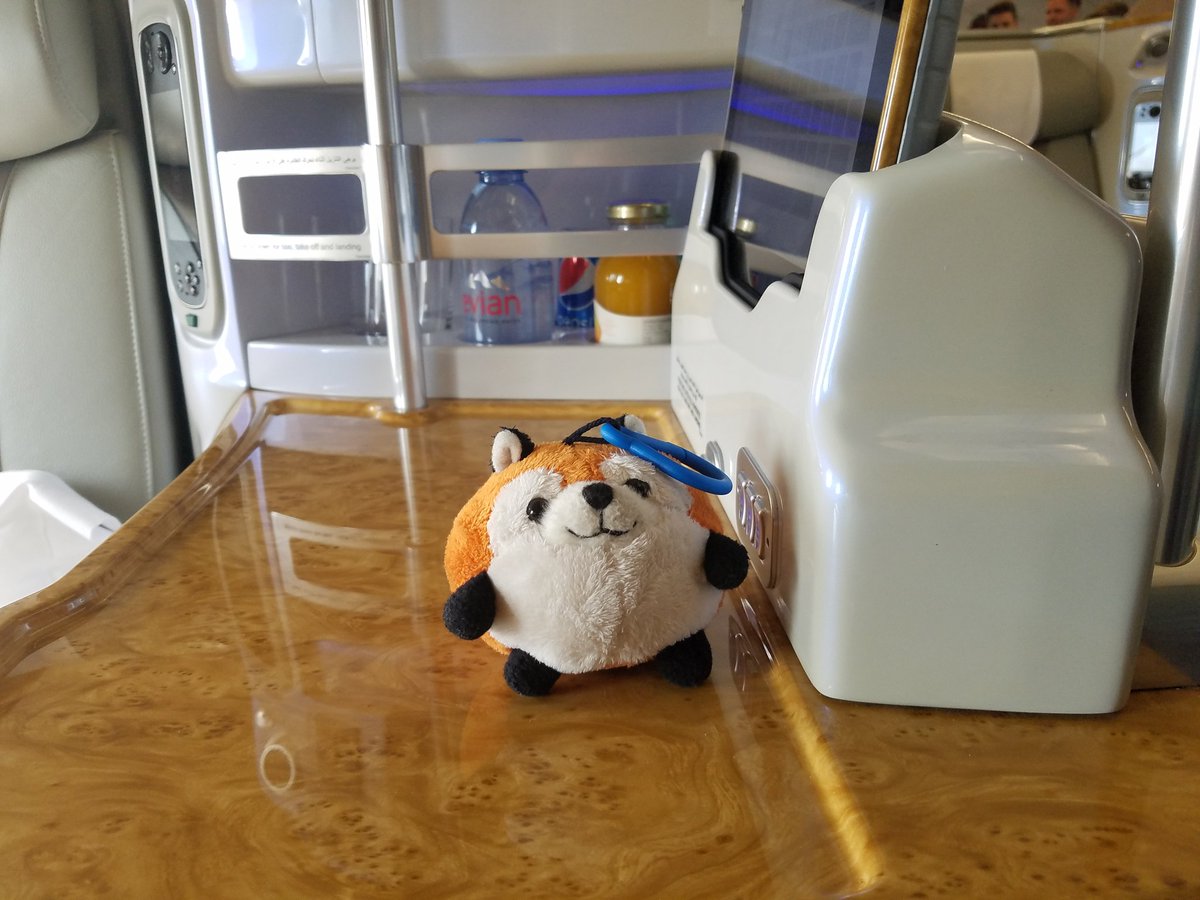 plush fox with a tablet and minibar in business class on an Emirates A380