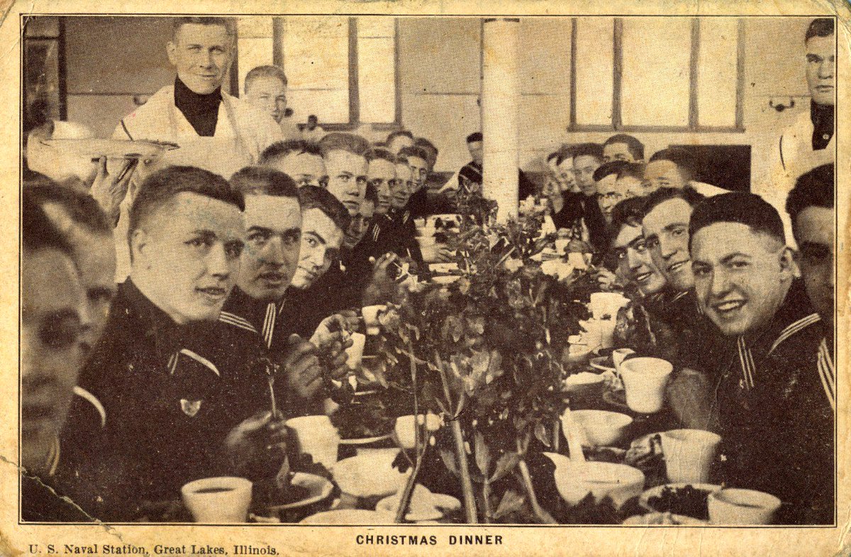 WWIChicago's tweet photo. How festive! Check out this holiday postcard from the sailors at Naval Station Great Lakes during that Bailey found in the @USNHistory archives. Students from Dr. Mooney-Melvin's #hist366 class @loyolahistdept are finalizing their website on @WWIChicago. Stay tuned! https://t.co/hPSJGnn7No