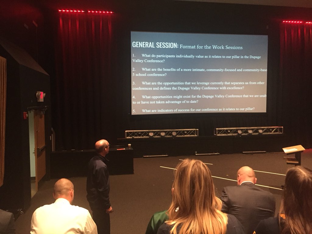 WVTV's tweet photo. Neuqua Valley principal Bob McBride speaking at a meeting today about the future of the Dupage Valley Conference. Teachers, advisors, coaches & administration from all 5 schools in attendance. #DVConference https://t.co/UEOhCVenHx
