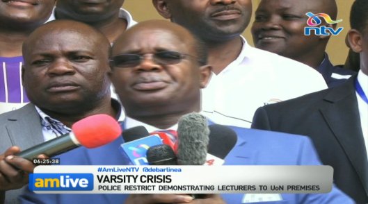 NTVnewsroom's tweet photo. Varsity crisis: Police restrict demonstrating lecturers to UoN premises. #AMLiveNTV @debarlinea https://t.co/OQJ5y6Cnqh