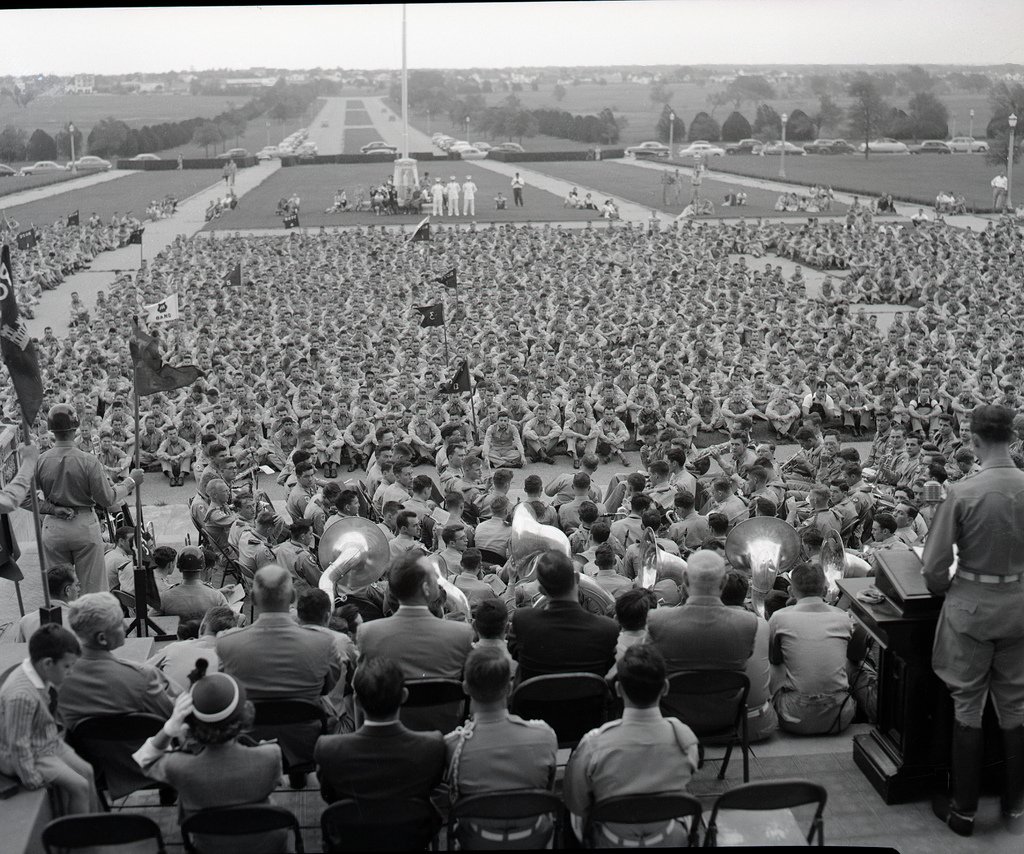 View from behind the band facing aggies sitting on the lawn outside of the administration building