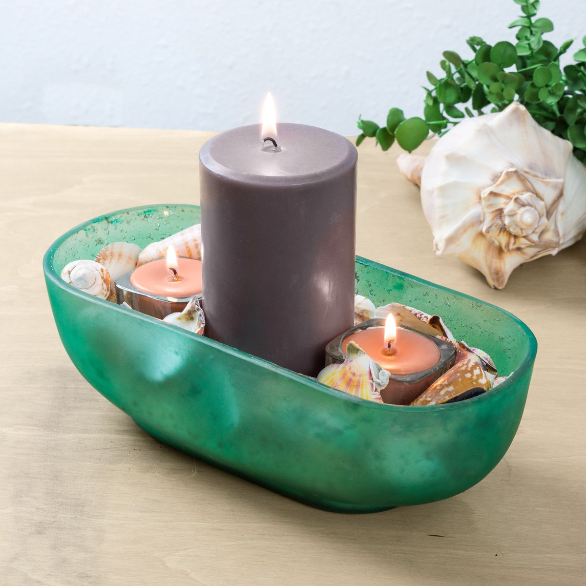 Happy Repurpose Thursday! What can you do with your tide pool boat vessels? Put more candles in them of course! We decided to stick with a coastal theme and fill the bottom with sand and seashells, but flowers, stones, and glass also make wonderful accents to  votives and pillars