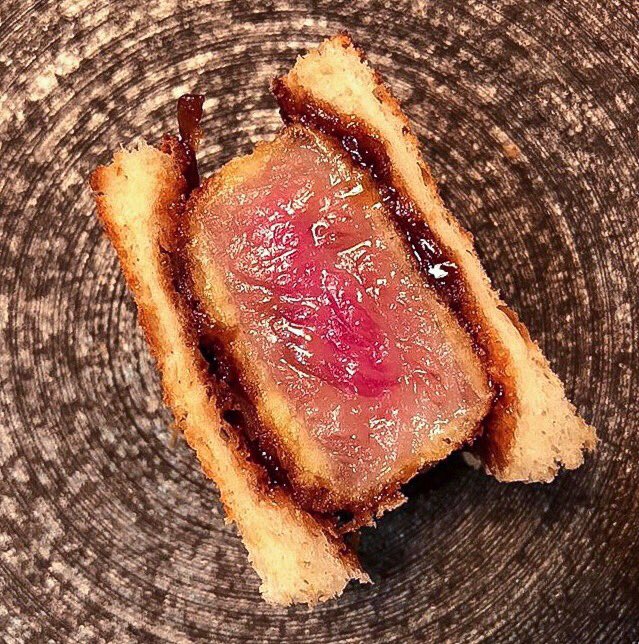 A sandwich of epic proportions: A5 Miyazaki Wagyu Beef Sando on Hokkaido milk bread with caramelized onion + tonkatsu sauce. #nextlevel