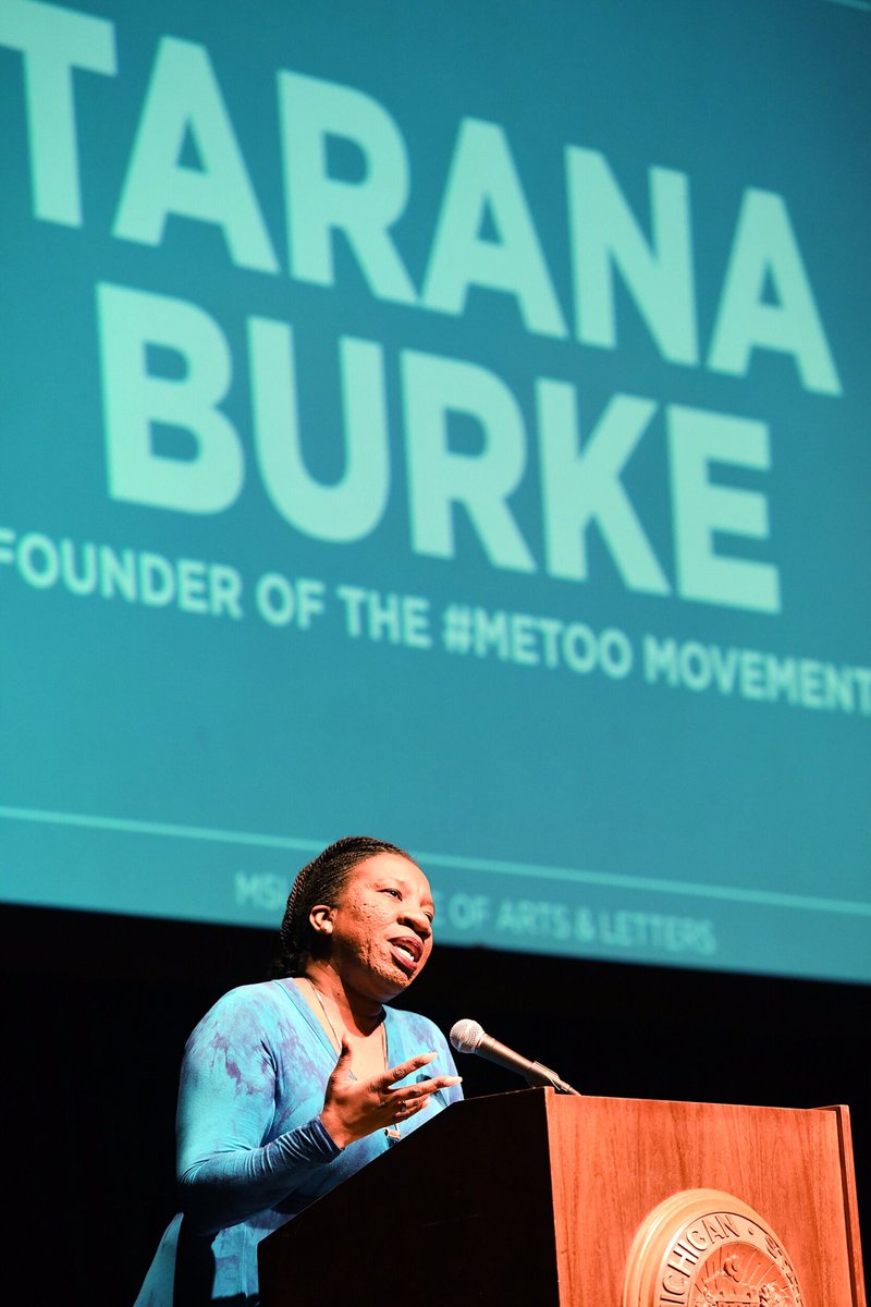 Women speaking in blue dress on stage