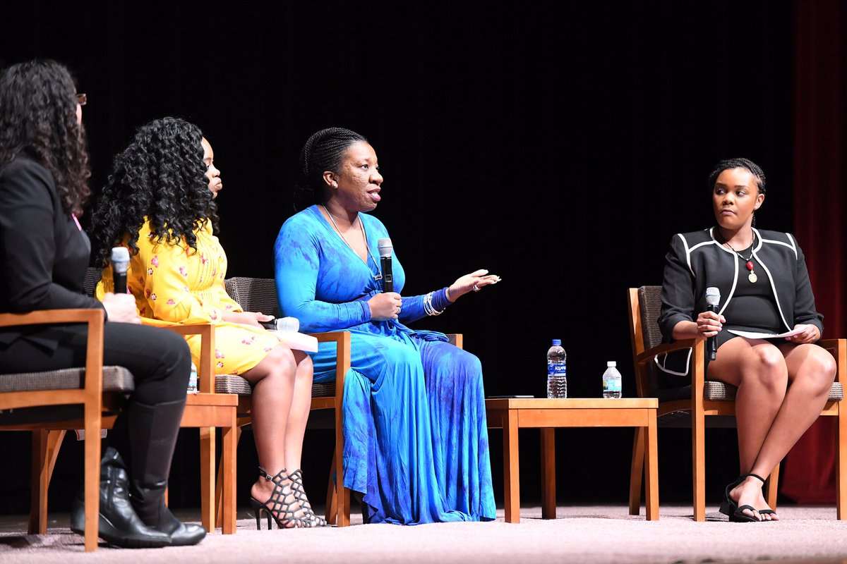 Four women speaking on stage