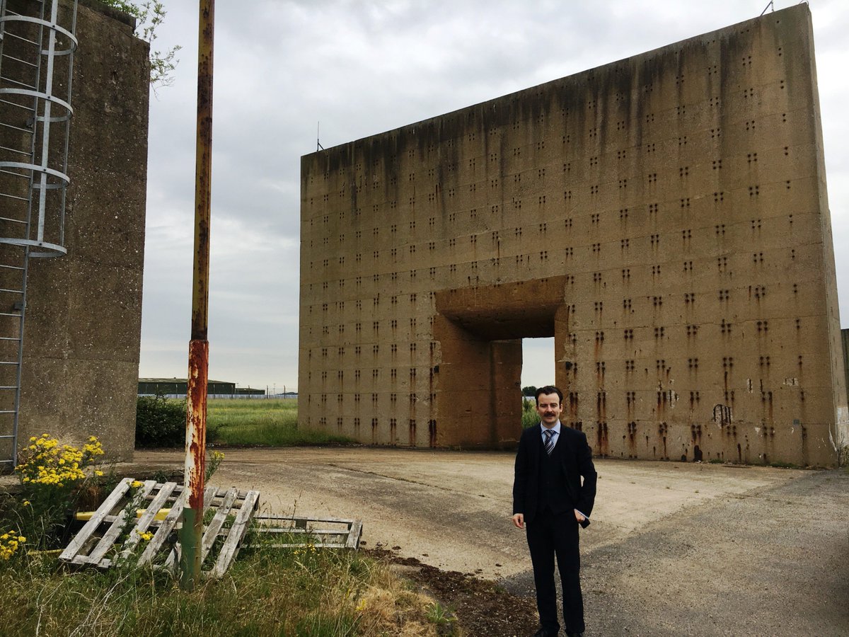PaulMarks12's tweet photo. The Westcott site is absolutely steeped in history. That holey wall behind rocketeer @Dan_Jubb is a Cold War rocket test blast shield, while grassed-over WW2 ammo stores now serve as mission control and firing bunkers. https://t.co/Lg6YIJidcJ