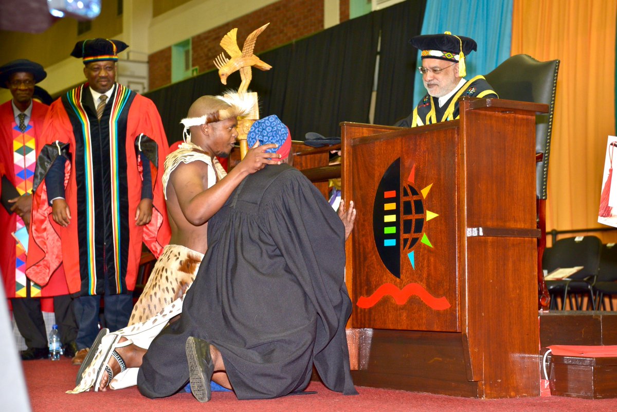 UKZN's tweet photo. The School of Law Graduation was agog this morning when Bachelor of Laws graduate, Njabulo Ntombela sporting ibheshu (Zulu traditional dress) took off his graduation gown and draped it on his great grandmother, Ms Nomkikilizo Ntombela (89). 
#UKZNgrad2018 https://t.co/UtSI9CPZrK
