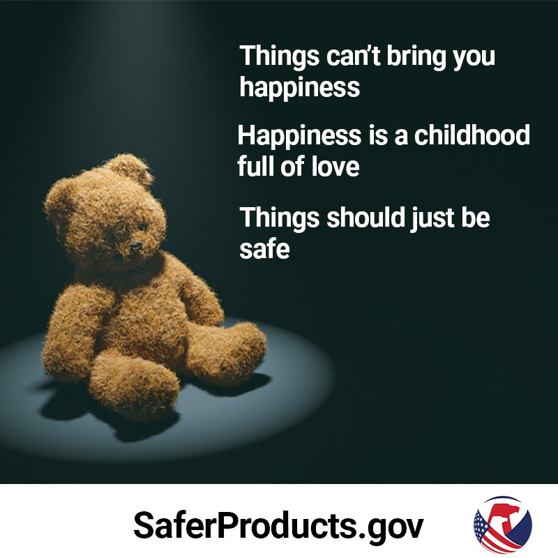 A stuffed bear sitting in a dark room under a spotlight. The text reads, "Things can't bring you happiness. Happiness is a childhood full of love. Things should just be safe - SaferProducts.gov.