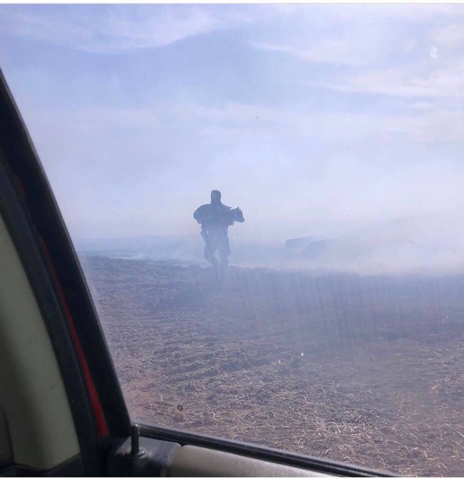 NYFarmer's tweet photo. A rancher carries calf out of burning pasture. Posted by Megan Greer on Facebook. https://t.co/KUl9NjoEcQ