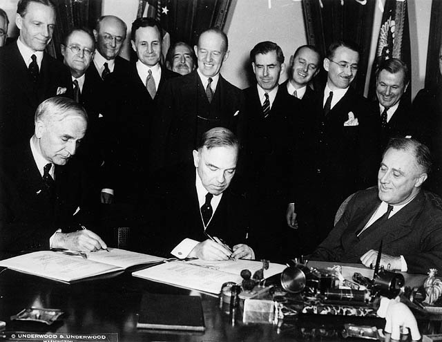 MackenzieKingPM's tweet photo. Cordell Hull, Me, and U.S President Franklin D Roosevelt, signing the US trade to Canada Agreement in 1935. This was our best act to stop, 'The Great Depression',  where it stabilized and managed our currency exchange rates, and helped both the US and Canada's economies. https://t.co/EfsF5Bojs0