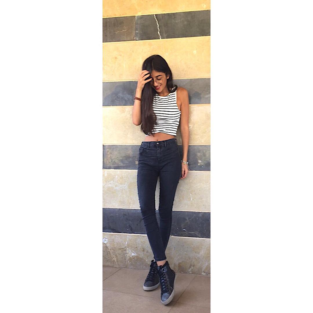The striped wall provides a perfect backdrop to these chic black #hightops. Killer! Photo Courtesy: Elissa Langill