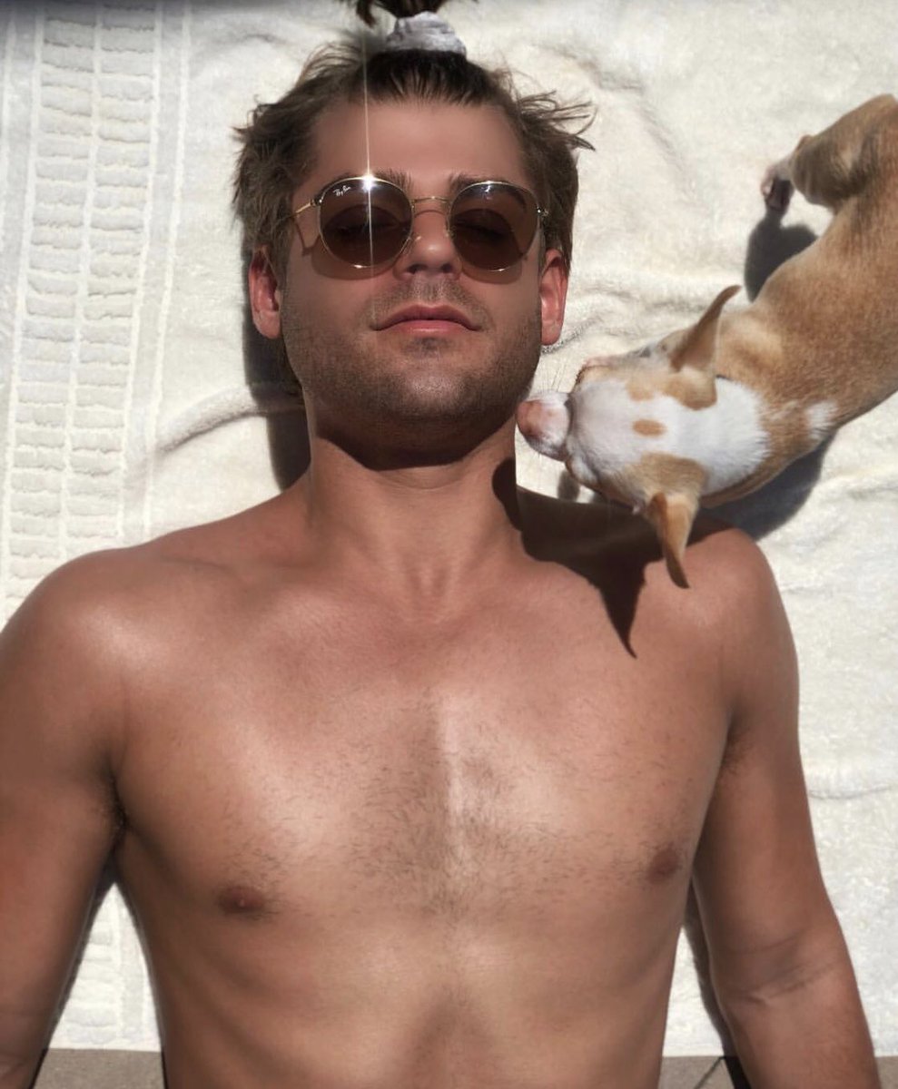 Krista_Carp's tweet photo. When you and your man are just chilling by the local pool and a little tiny doggo comes up for a sniff and yes @Clayton_Garr is wearing his hair in a little ponytail https://t.co/qAtM392Nwv