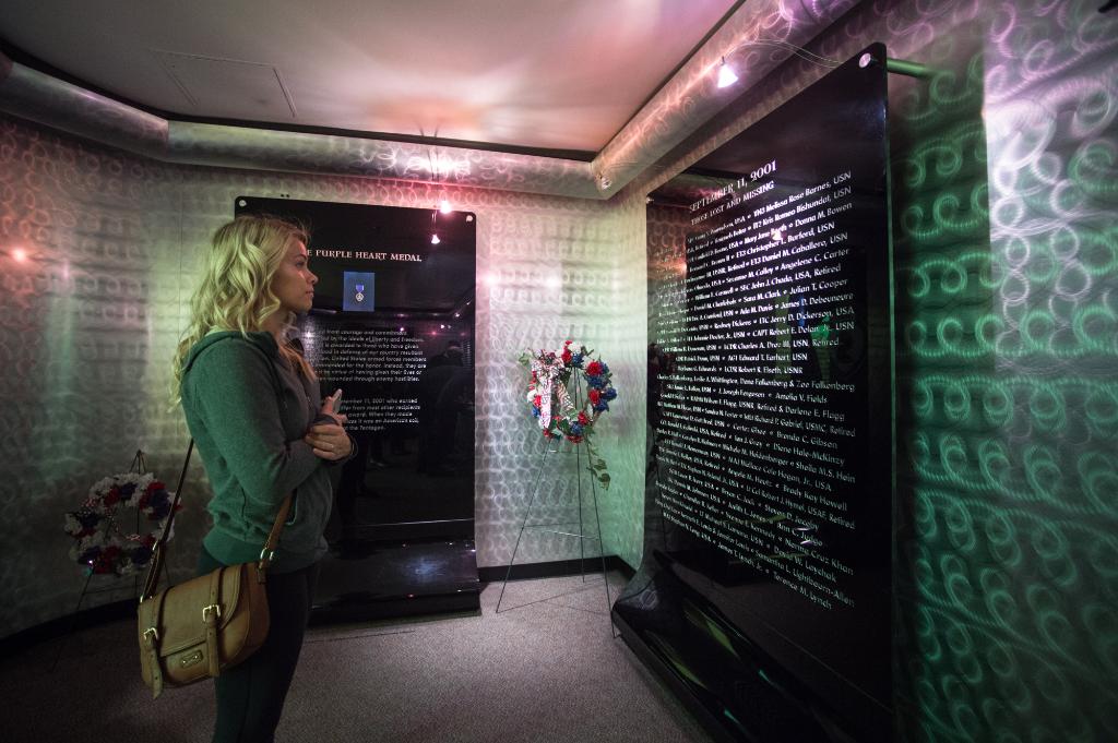 Professional UFC fighter, @PaigeVanzantUFC, pauses for a moment in the Pentagon 9/11 American’s Heroes exhibit before departing on the annual Vice Chairman’s USO tour. #USOViceTour

[@DeptofDefense 📸 by U.S. Army Sgt. James K. McCann]