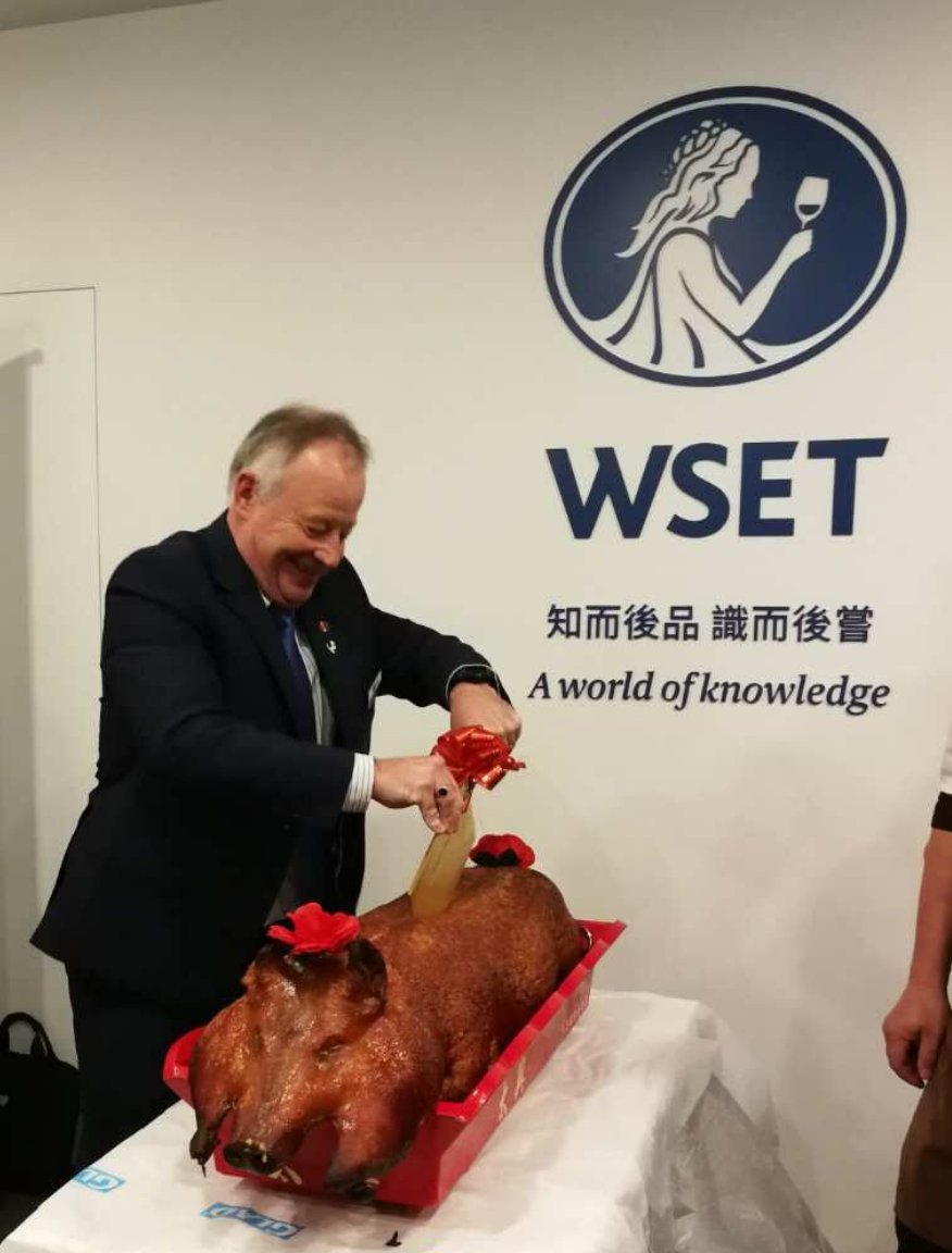 Just1nHS's tweet photo. Slightly bizarre image in @teamdb of @Ianharris1955 celebrating the opening of the @WSETglobal office in Hong Kong by taking an axe to a pig.... #notsuitableforvegans https://t.co/P9Vt14xoDX