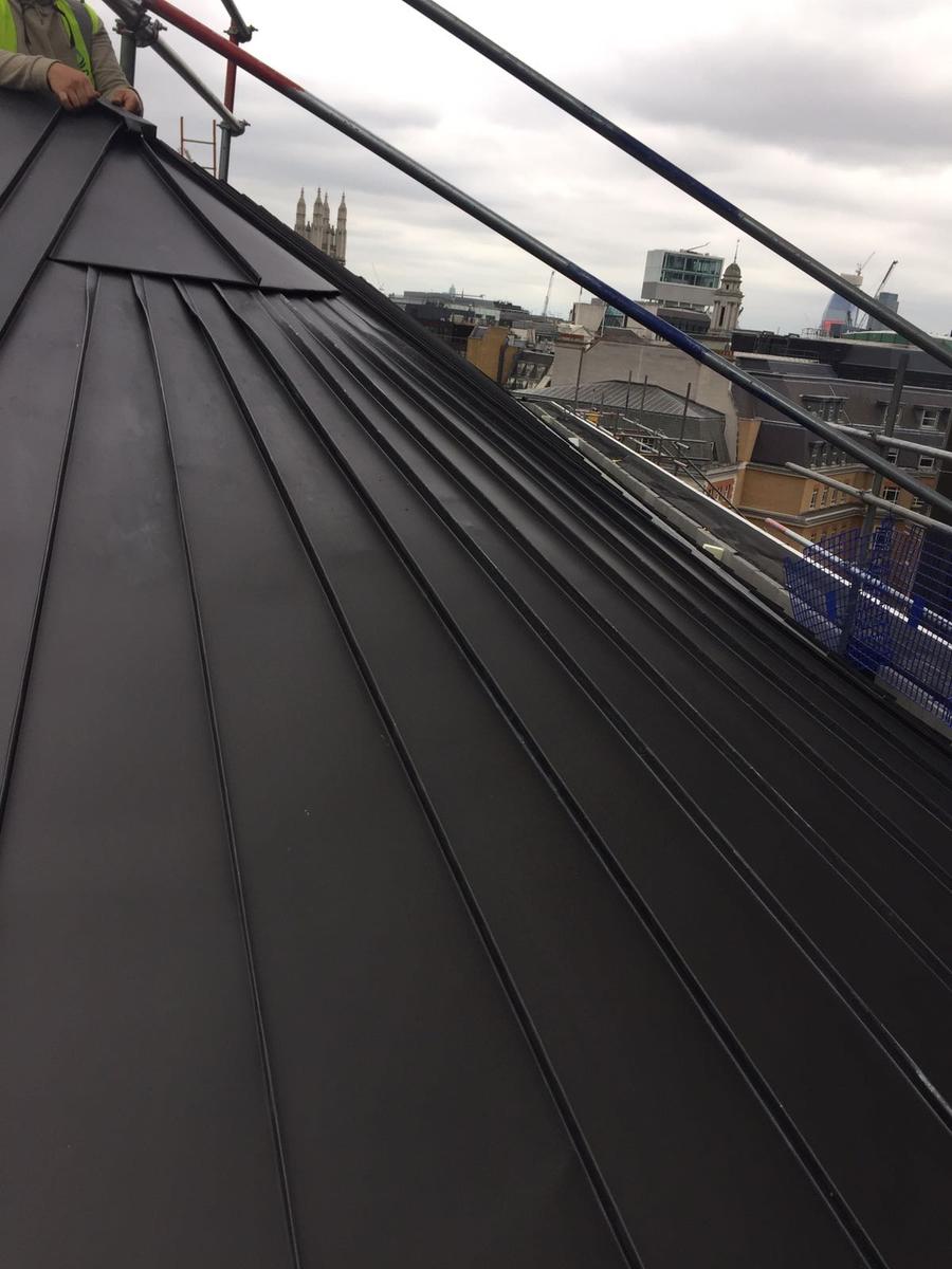 Client: Alltech Roofing Ltd 
Material: VM Anthra PLUS 
At Bishopsgate we installed traditional standing seam panels to a plant room roof. This project also included a cone shaped section which involved installing individual tapered panels to create the curve.