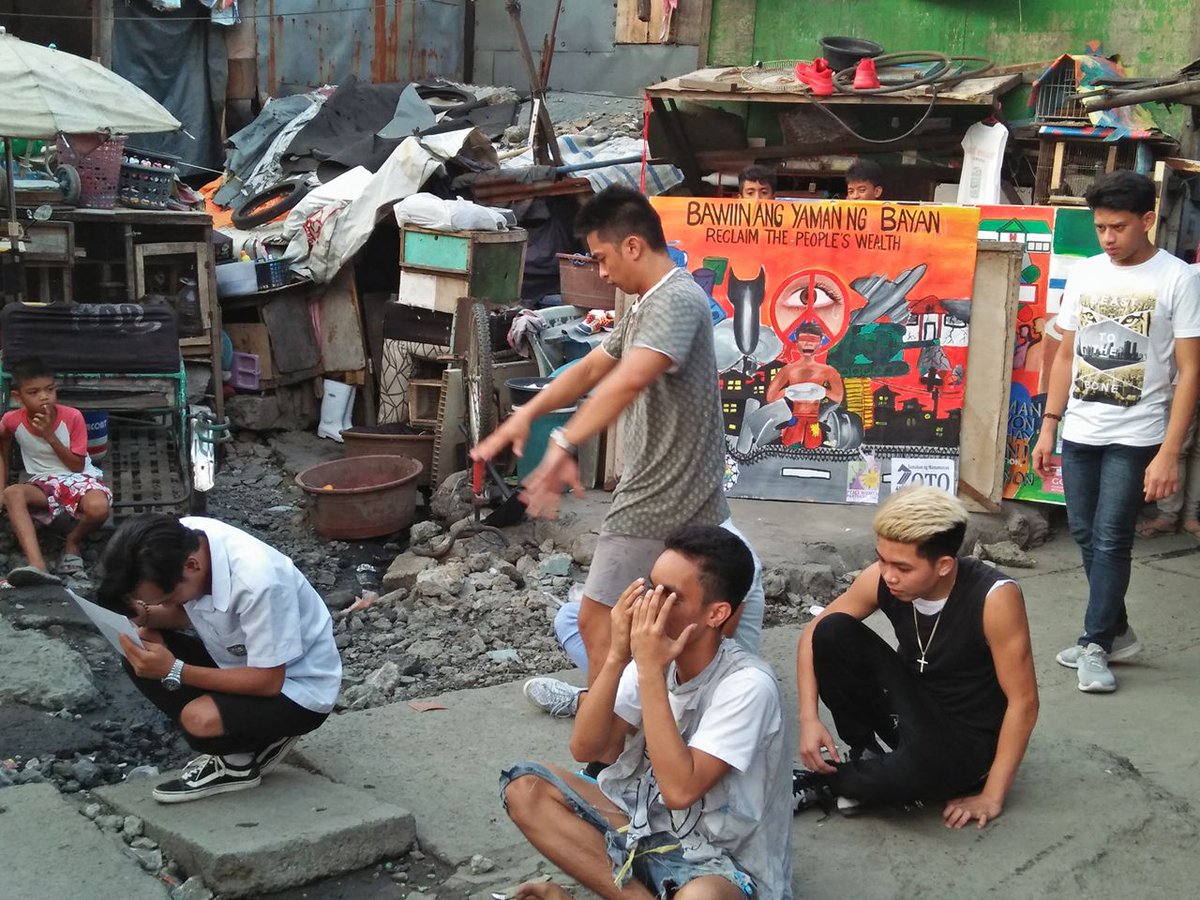 DemilitarizeDay's tweet photo. Powerful pictures from #GDAMS event of April 21 in Manila, Philippines, with the reading of a poem titled "Reclaim the Wealth of People" and a street dancing performance #movethemoney to health & education and #demilitarize! #GDAMS2018 https://t.co/NC0qVwa1mg