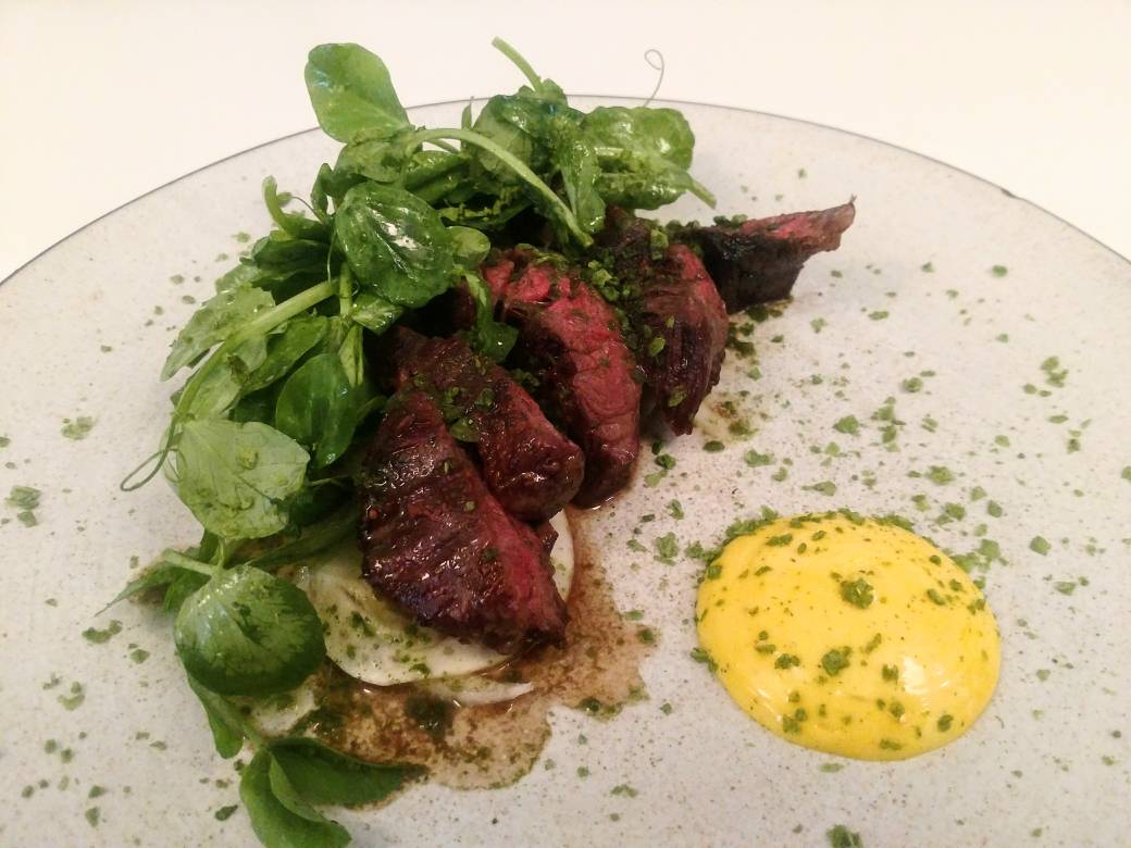 Hanger steak with shaved fennel, pea tendrils, ramp salt &amp; saffron aioli.
