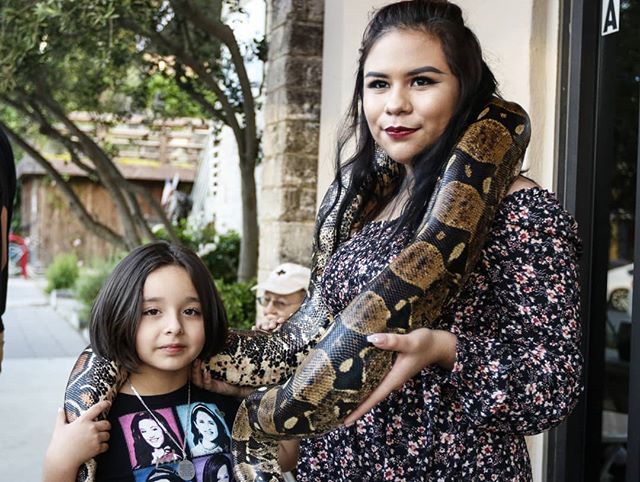 DCatheyPhoto's tweet photo. A Burmese python lightly coils around the necks of cousins Alyssa Gomez and Serena Reyes at the Homies With Scales booth during 3rd Thursday Downtown Walkabout. #reptiles #snakes #python #portrait #streetphotography #smtx #sanmarcos #texas #photojournali… https://t.co/DWMlsvmY8i https://t.co/2XvvPYxM8r