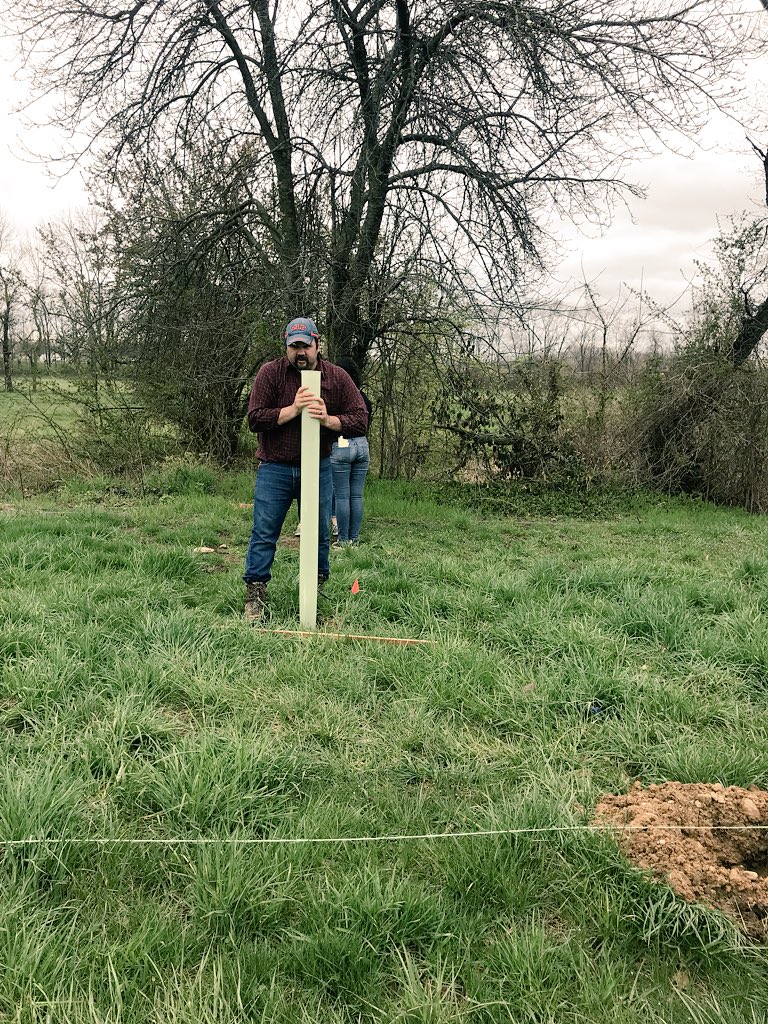 Dr. Cornell teaches students how to put protective tubing around newly planted trees to protect from animals. #RecycleShip #GESO