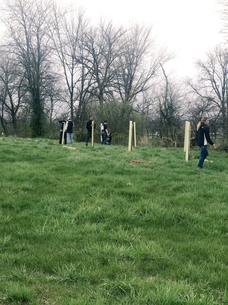 Shippensburg University students begin working. Placing protective tubes atop new trees. #RecycleShip #GESO