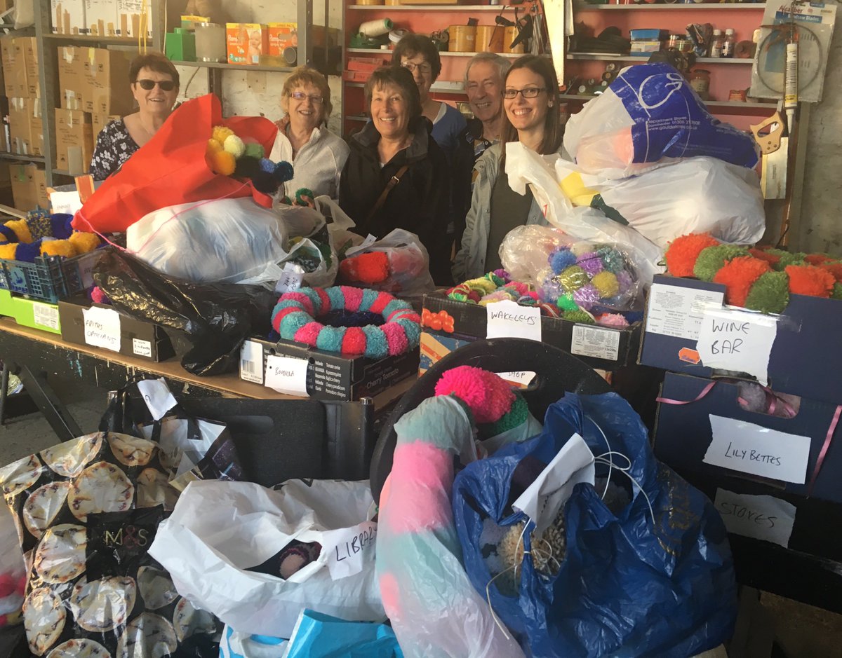 C_Crewkerne's tweet photo. Shop Drop completed! Thank goodness for so many helpers making quick work of delivering pom poms ready for shops/businesses to put up (even more volunteers arrived after the photo) https://t.co/y1wetqIeXs