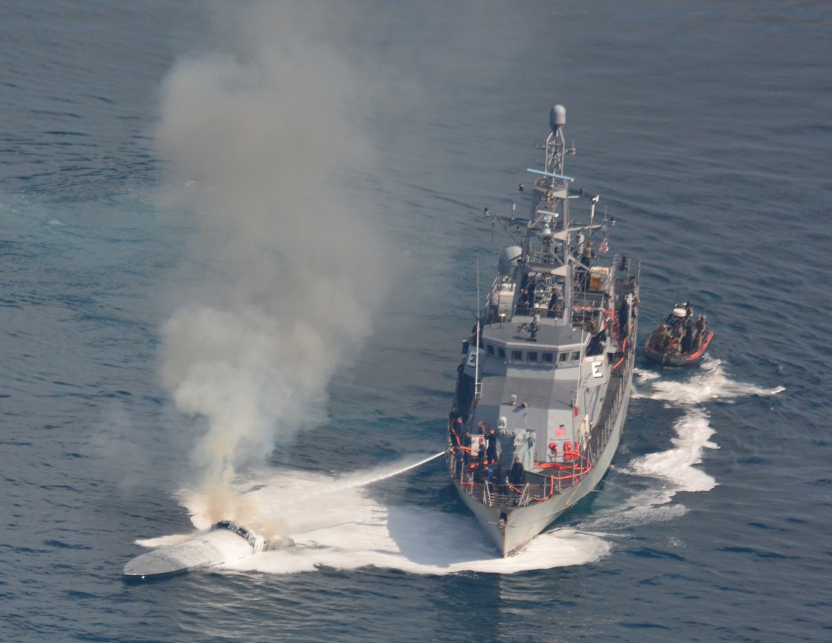 Cyclone-class patrol coastal USS Zephyr (PC 8) crew conducts ship-to-ship firefighting to extinguish a fire aboard a low-profile go-fast vessel suspected of smuggling in international waters of the Eastern Pacific Ocean April 7, 2018.