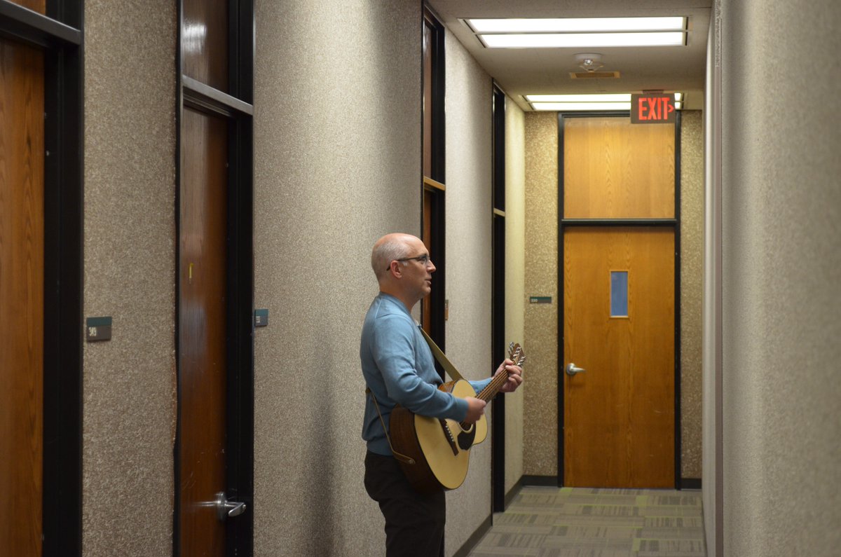 UNTEcon's tweet photo. @UNTEcon enjoying some music during a few moments of downtime.  Here's Dr. Jeff Rous wandering the halls of the Econ Dept., strumming and singing, enticing faculty members Jiyoung Kwon and Harry Ellis out of their offices.  Good times! 🙂🎸🎶
#UNT #acadowntime #coolteachers https://t.co/ahYbxvttHo