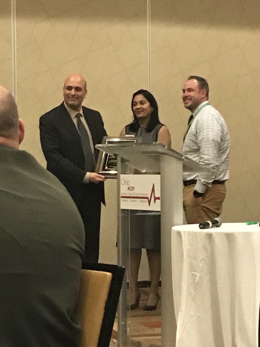 OhioACEP's tweet photo. Dr Emile El-Shammaa accepts the EM Physician of the Year Award from @OSUEMEdu’s @DrNickKman &amp; Dr Grover. Congrats! #EMForum18 https://t.co/GQhT4mYKEB