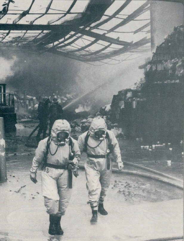 MoF_Sydney's tweet photo. Chemical suited firefighters emerge from a Silverwater factory after chemical fire, 1 December 1983. #FlashbackFriday @FRNSW https://t.co/4EmzUkARZp