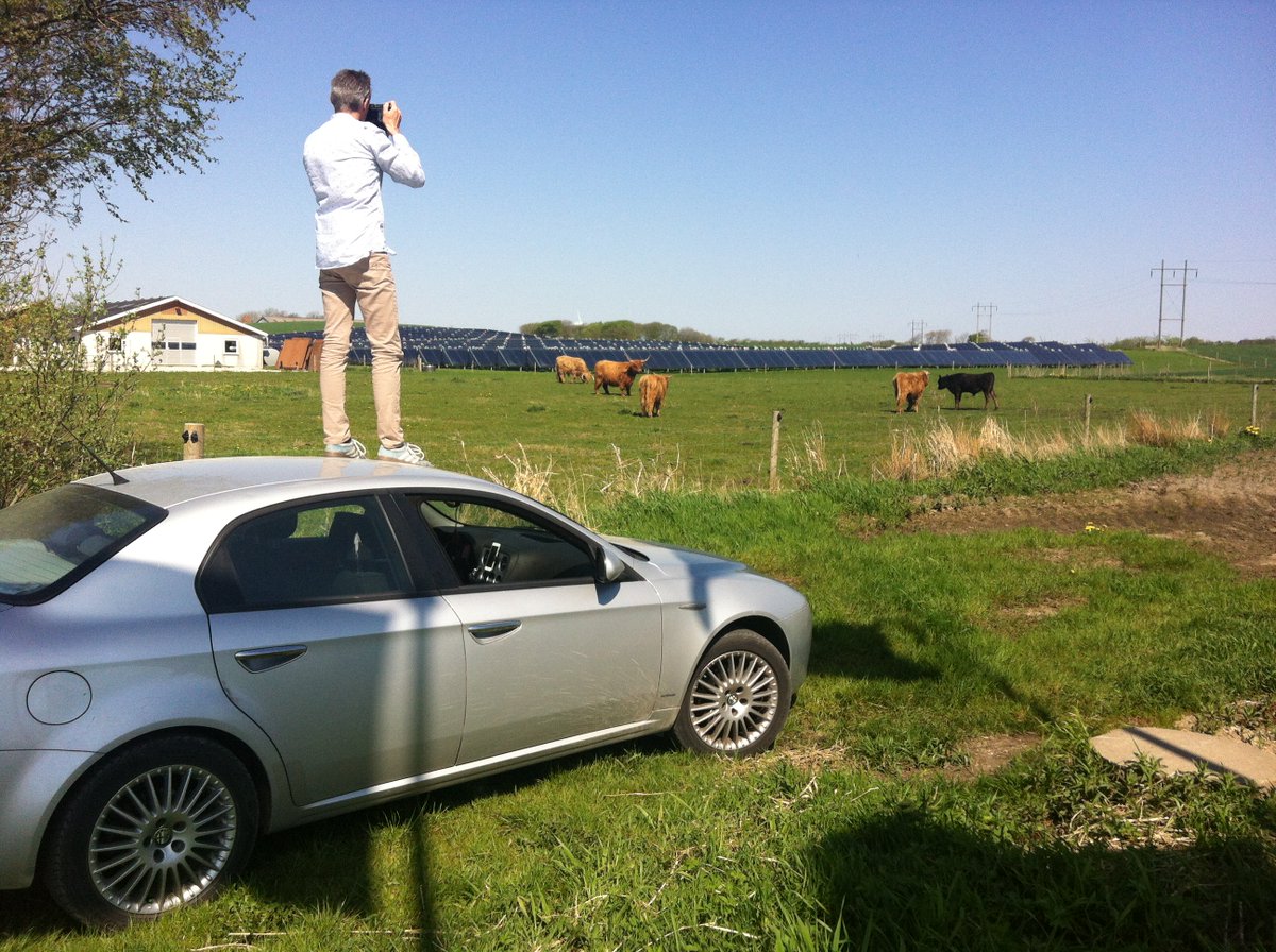 <a href="/MerlinDaleman/">Merlin Daleman</a> on a car looking at cows and solar panels. This is becoming a pattern.  #reportersinthefield in Denmark. <a href="/fieldreporters/">Reportersinthefield</a>