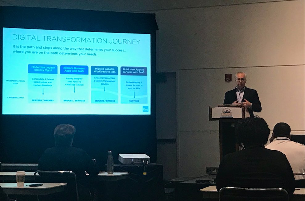 pingidentity's tweet photo. Loren Russon, Ping Identity VP of Product Mgmt presents the top transformational approaches to a modern hybrid identity architecture at #RMISC2018 earlier today! Come by our booth to learn more. #RMISC https://t.co/iNxwZDHgJT